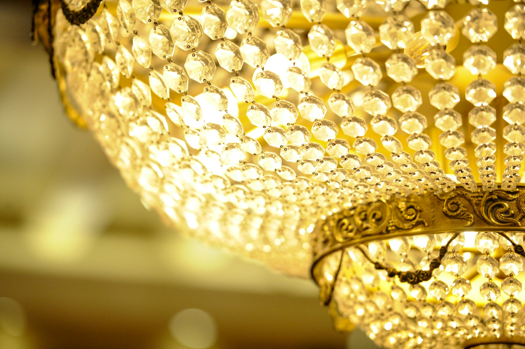 Warm light catching the individual crystals of a chandelier